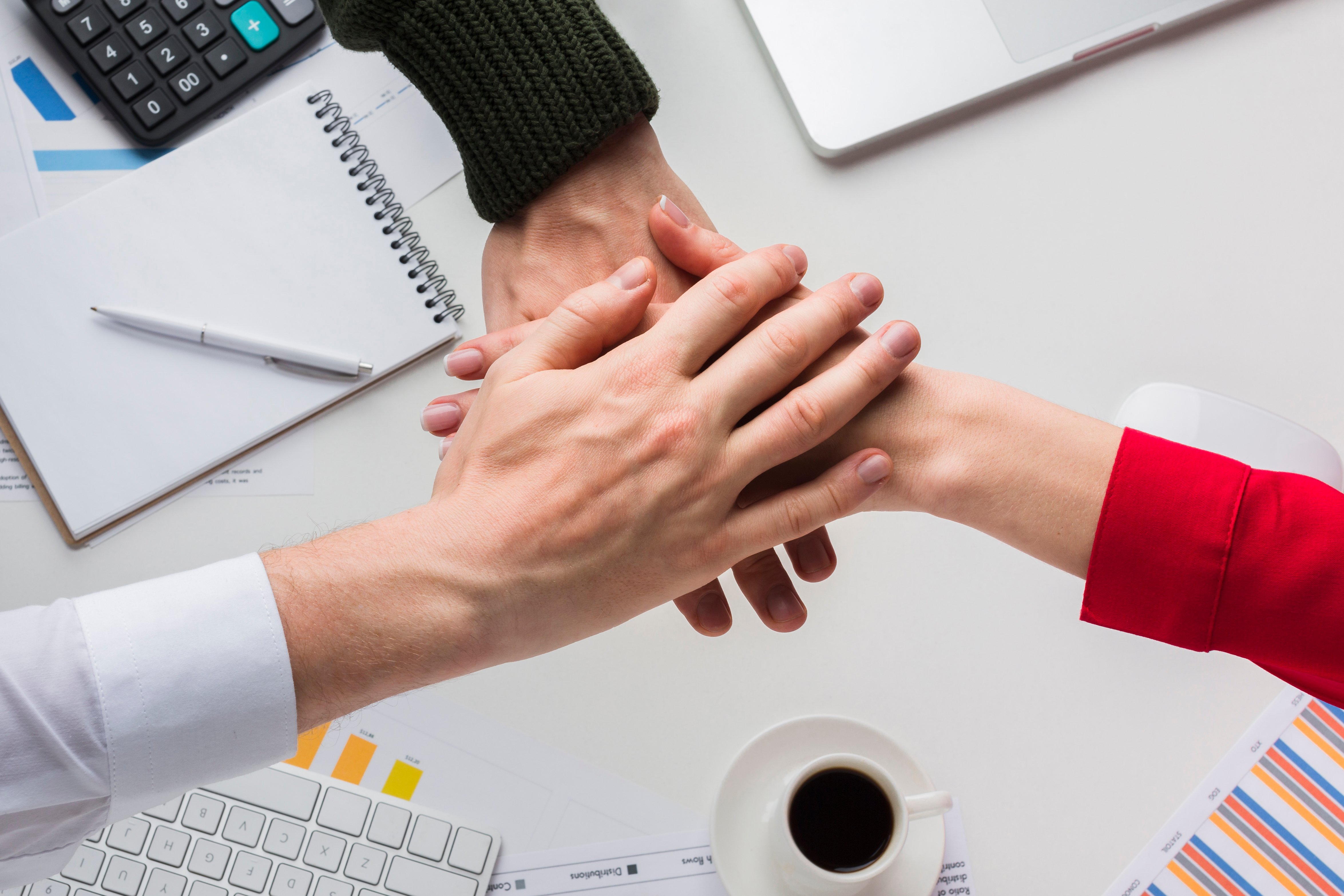 top-view-hands-together-desk
