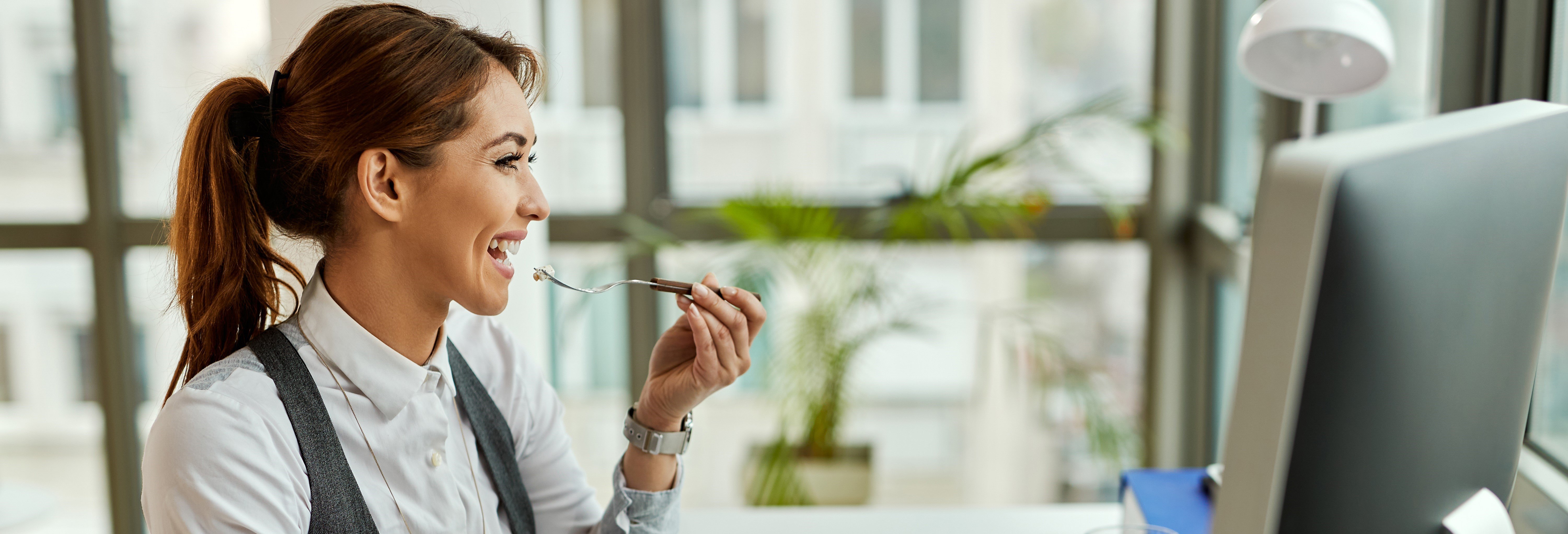 young-happy-businesswoman-eating-break-office