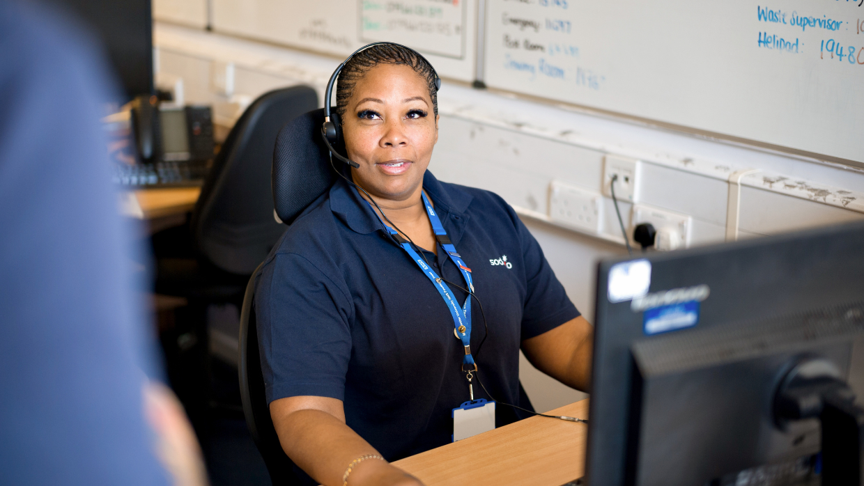 female-call-handler-with-headphones-and-computer