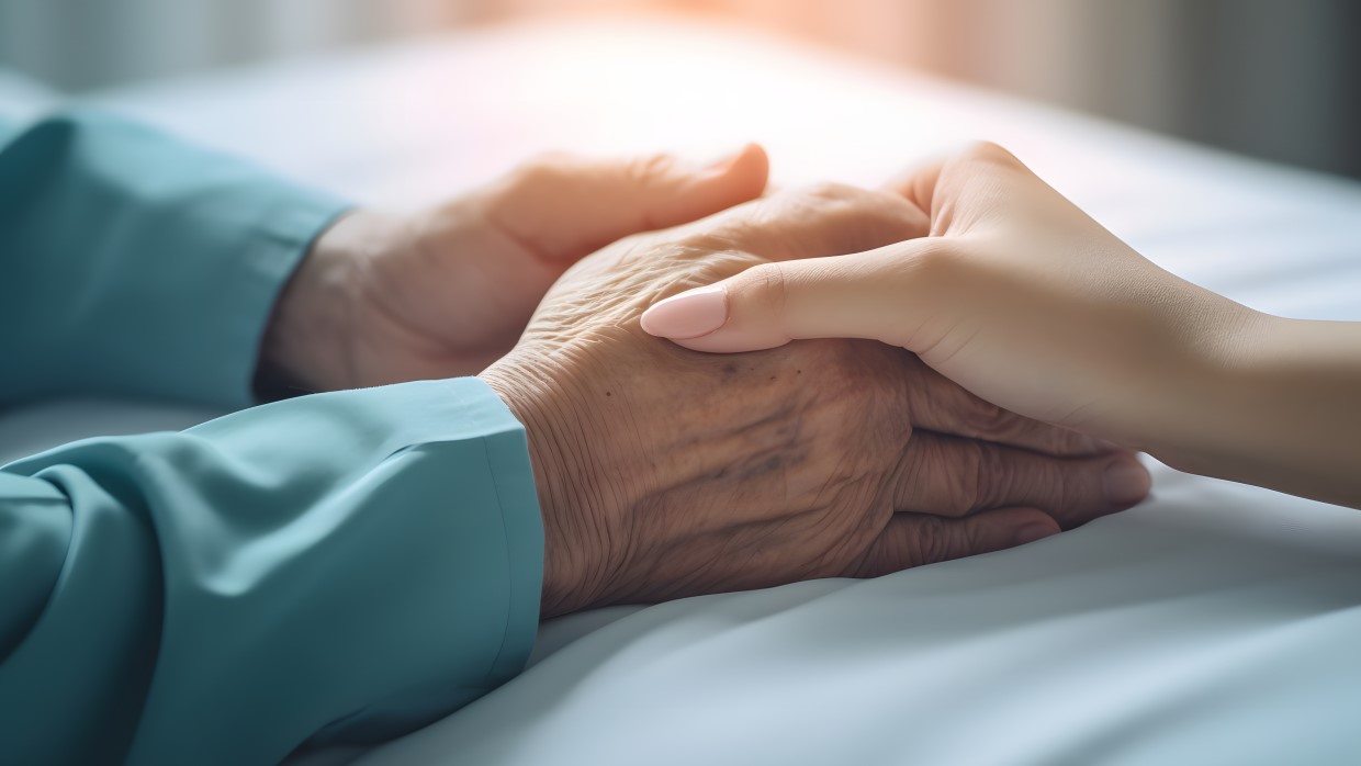 An elderly person holding the hand of a young woman, showing love and support.