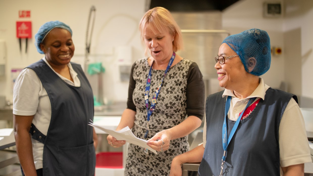 Catering team reviewing patient dining paperwork.