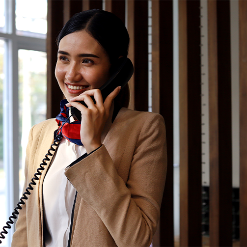 A young east asian woman talking on the landline