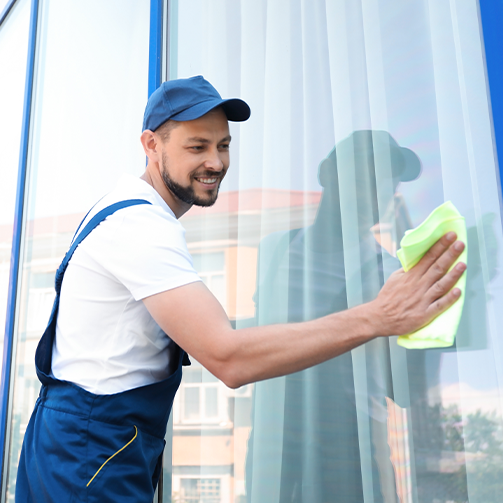 A worker cleaning window from outside