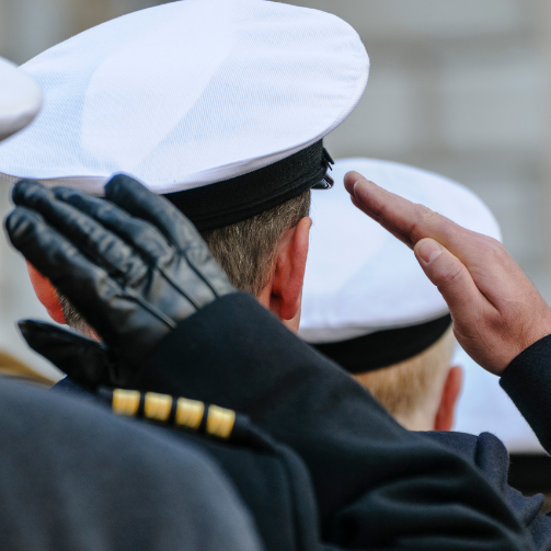 A group of military men in uniforms saluting