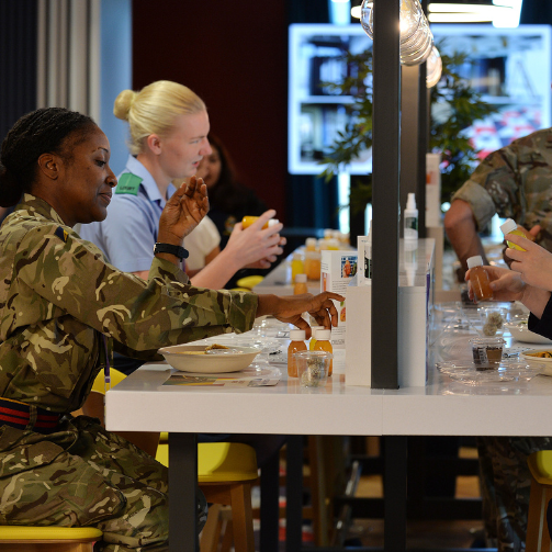 Female soldier in camouflage military uniform standing confidently
