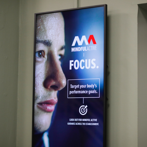 A screen with the image of the face a young man looking at the horizon
