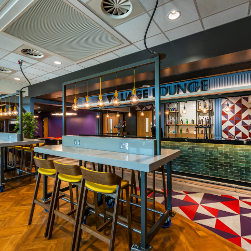 A bar with colorful tiles and a stylish bar counter