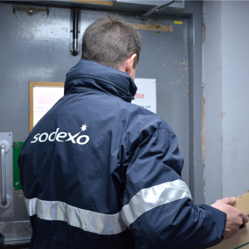 Sodexo employee carrying a box