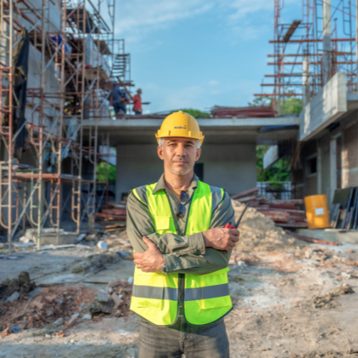 Worker in front of camp construction