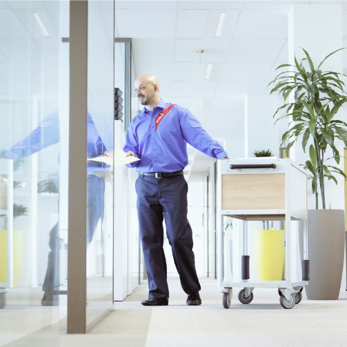 Sodexo employee distributing mails in an office space