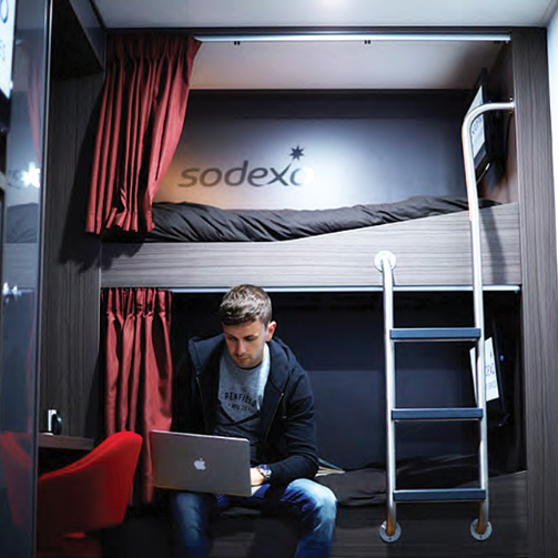A man working on a laptop in his offshore cabin