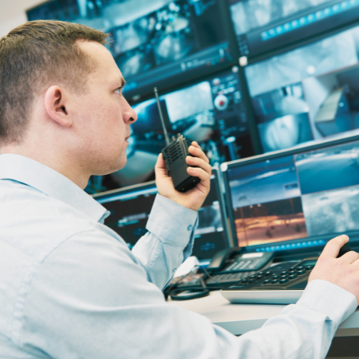Sodexo employee controlling CCTV screens with a walkie-talkie 
