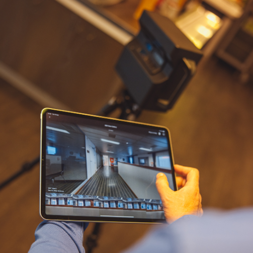A person holding a digital tablet presenting a space re-arrange