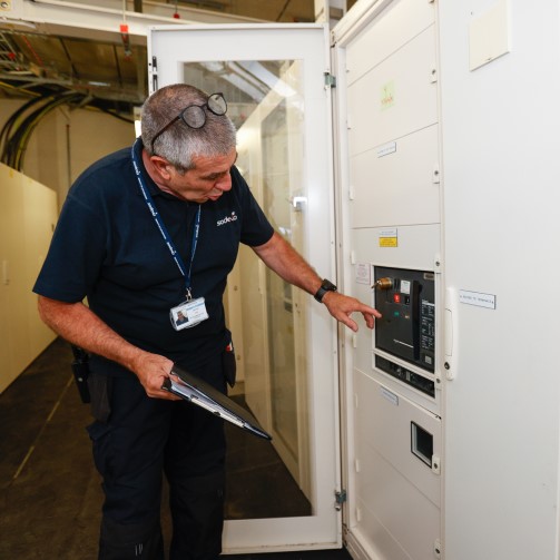 A male worker checking an electrical panel