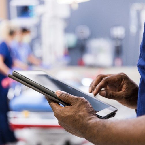 A pair of hands holding a tablet