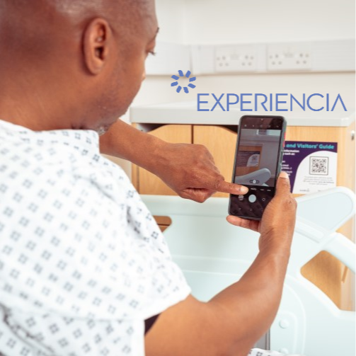 Patient in a bed scanning a QR code to access hospital information