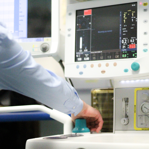 An hand of a male interacting with medical equipment. 