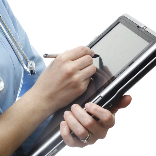 Hands of a nurse is writing on a tablet using a screen pen