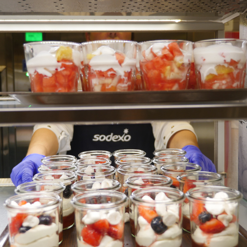 A Sodexo chef displaying a food counter