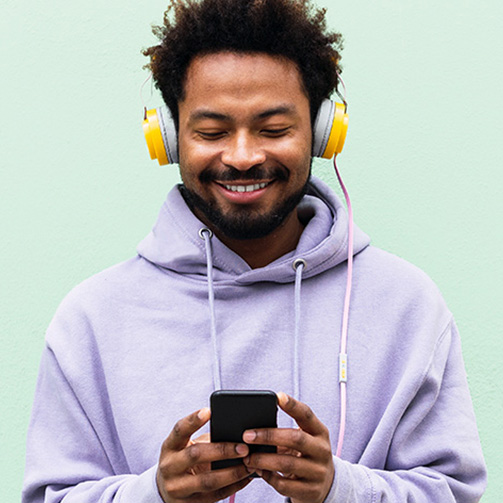 A man wearing headphones, immersed in music, enjoying his audio experience