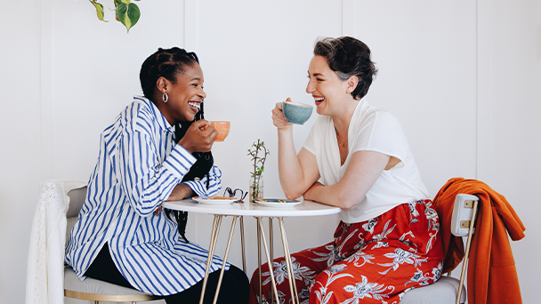 Two women drinking coffee and talking