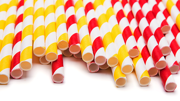 A group of yellow and red straws in a pile