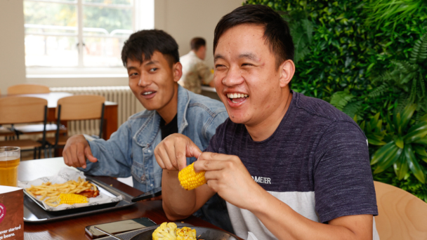 Two men enjoying a meal together at a dining table