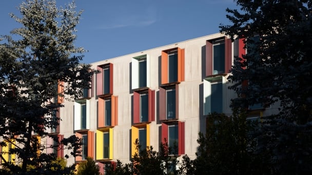 A building adorned with numerous windows and colorful shutters