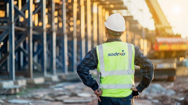 Sodexo worker looking at camp construction site