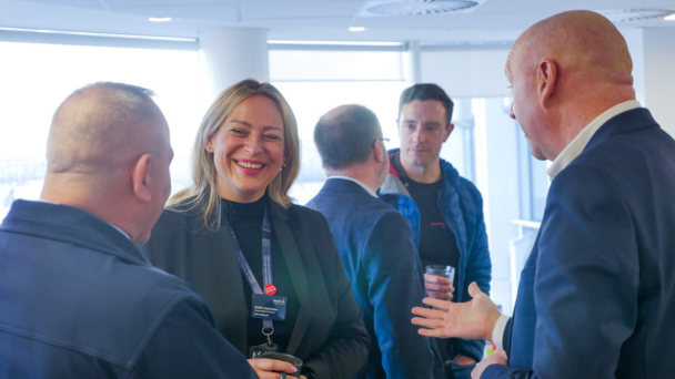 A diverse group of professionals engaged in a discussion in a modern office setting