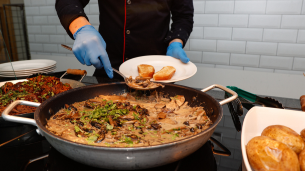 A plate of food being served at a food station