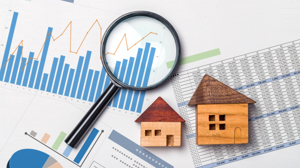 House model and price graph with magnifying glass