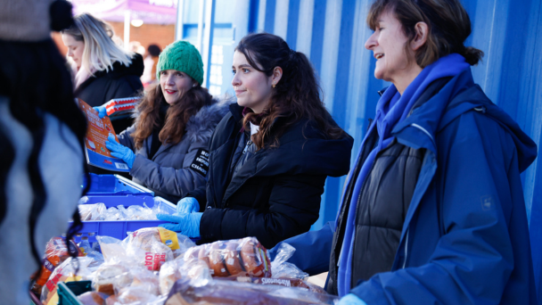 A group of people gathered around a table filled with food