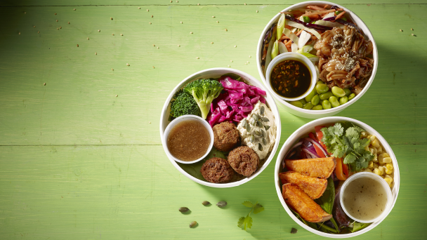 Three bowls of food on a green table: a delicious assortment of dishes.