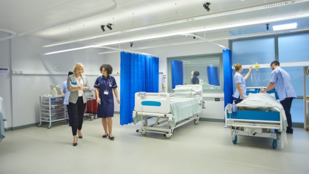 Manager and Nurse discussing plans while in a ward environment