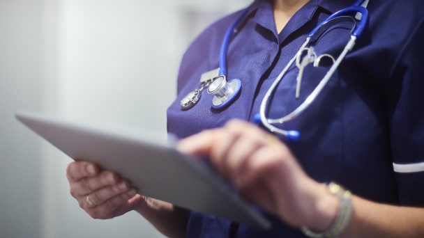 Hands of a doctor is using a tablet