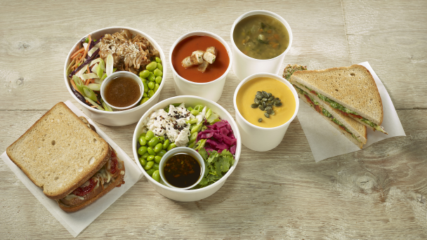 A table with bowls of food and a sandwich, ready to be enjoyed.