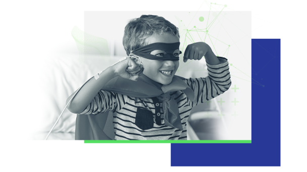 A young boy wearing a superhero mask and cape