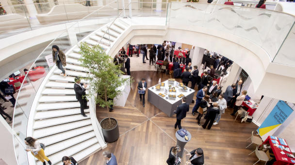 Overhead view of guests networking in an open foyer at a conference reception