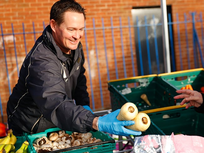 man giving vegetables