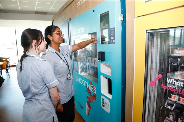 Two nurses ordering smoothies from 24/7 automated vending solution