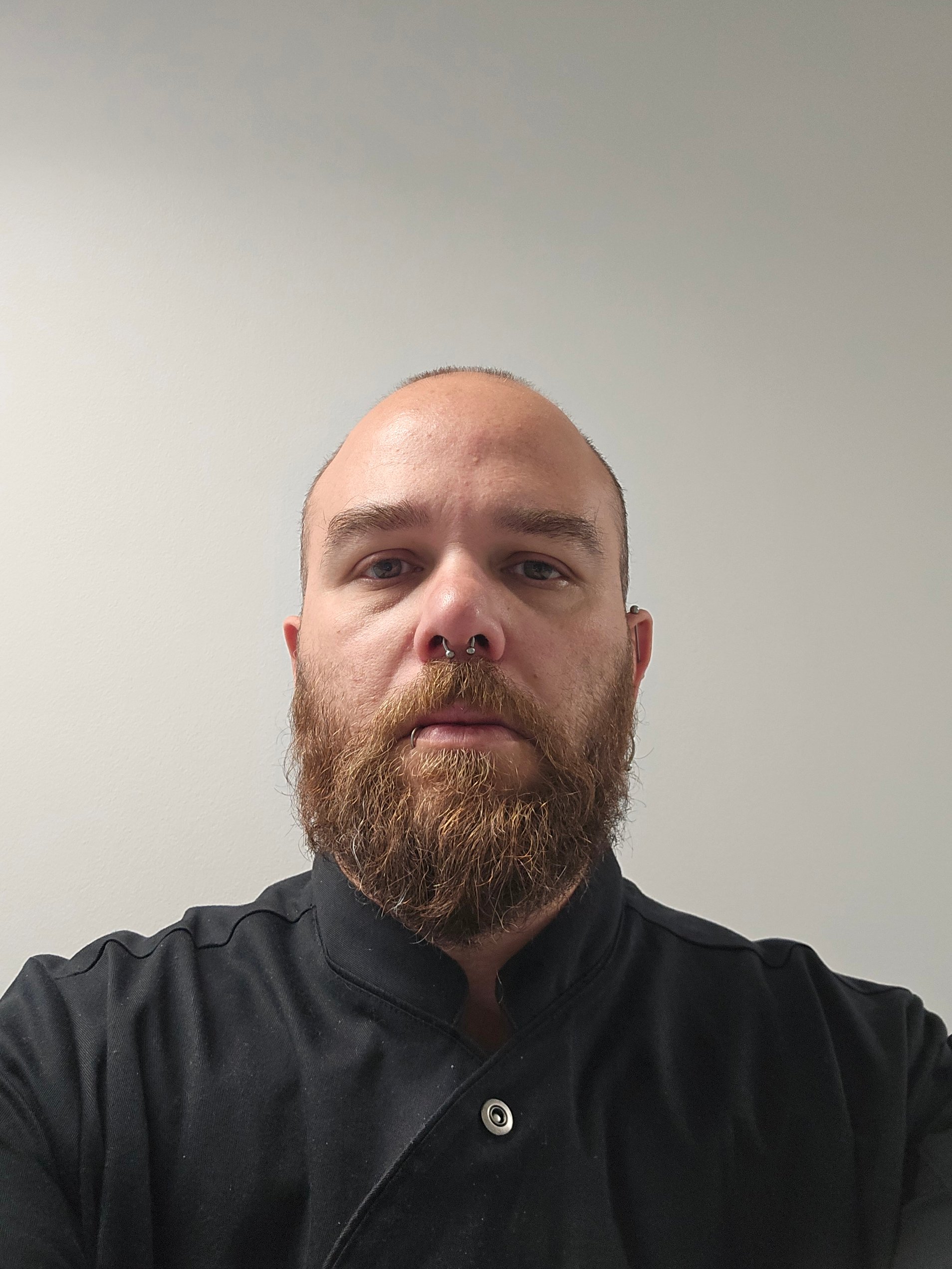 Professional headshot of a colleague against a plain background.