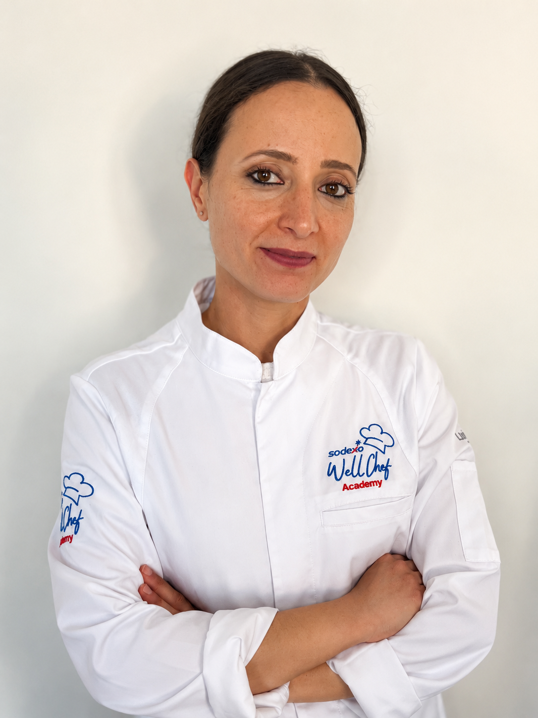 Person in a Sodexo chef’s jacket posing for a professional staff portrait.