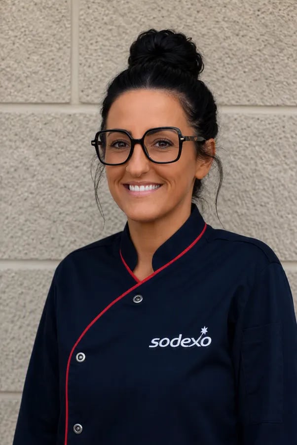 Person in a Sodexo chef’s jacket posing for a professional staff portrait.