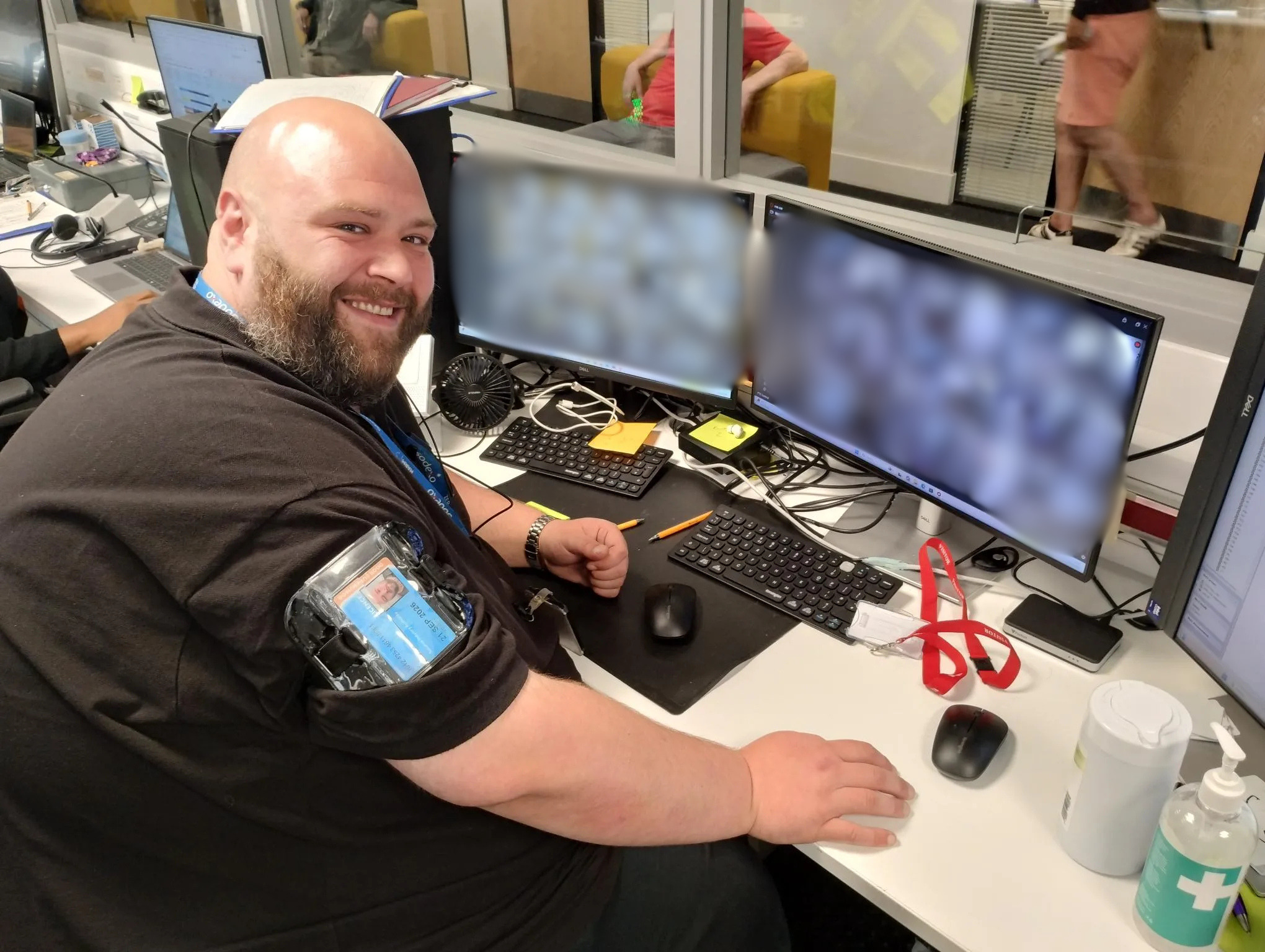 Sodexo colleague seated at a workstation monitoring CCTV camera feeds across multiple computer screens.