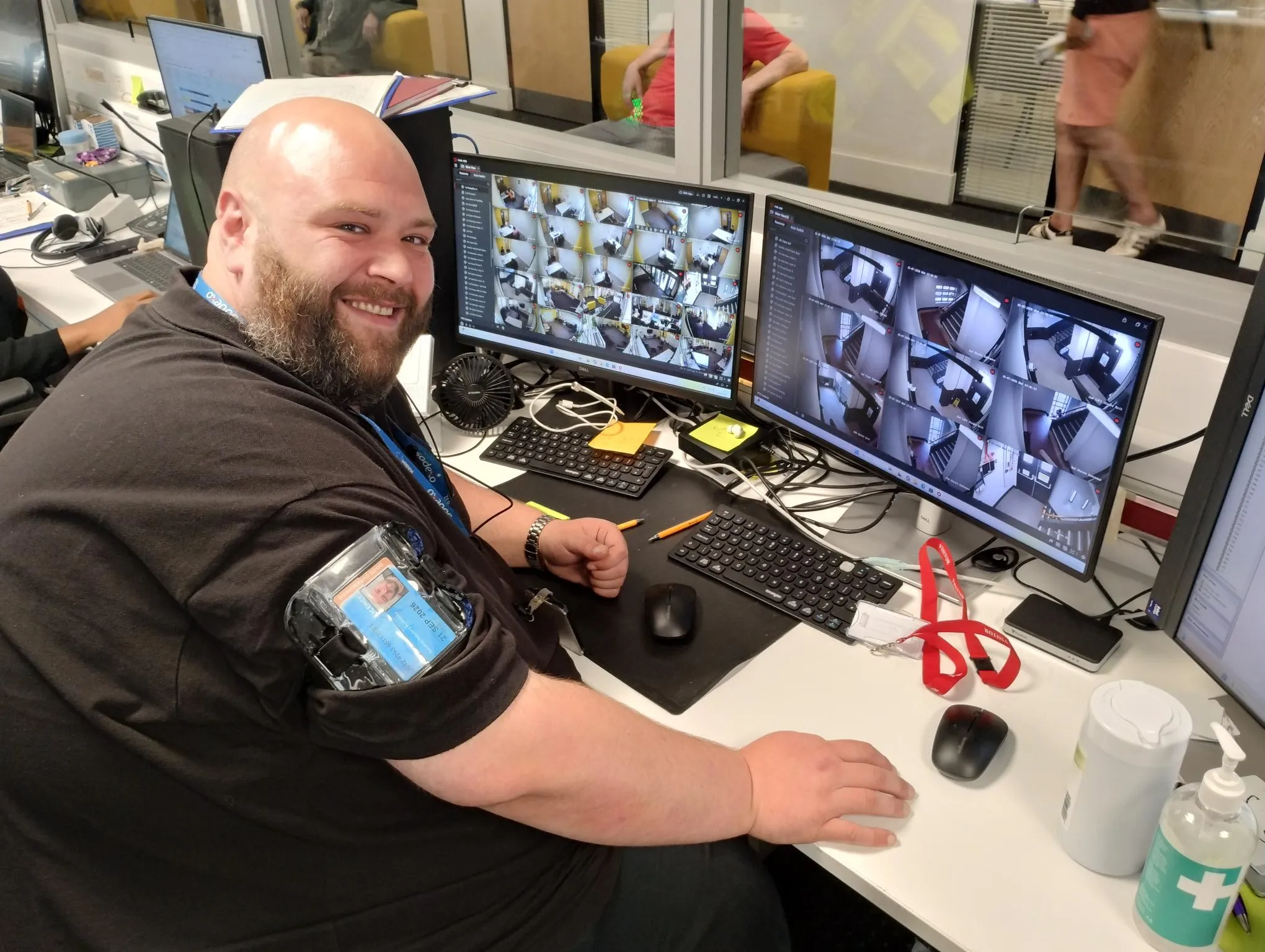 Sodexo colleague seated at a workstation monitoring CCTV camera feeds across multiple computer screens.