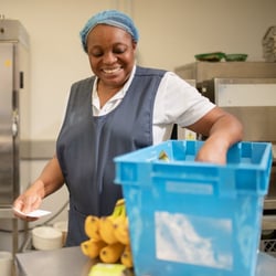 employee taking bananas from a box