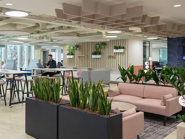 A spacious modern office with an open layout, featuring contemporary furniture and ample natural light