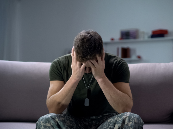 A soldier in uniform relaxing on a couch