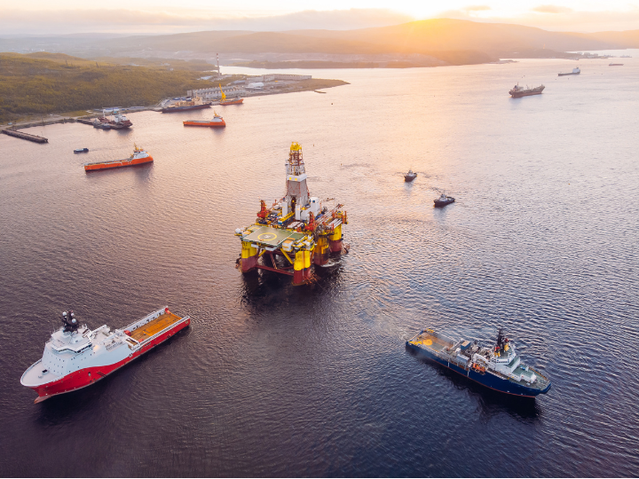 An offshore oil rig surrounded by vessels